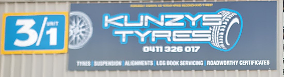 The Kunzys Tyres sign, with the old Struchaire Secondhand Tyres name in small print along its top edge